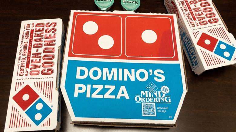 Domino's pizza boxes on table