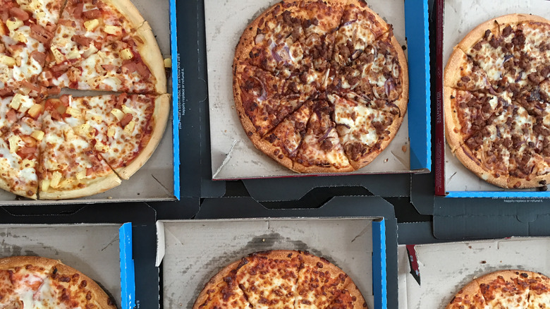 Six Domino's pizzas in boxes