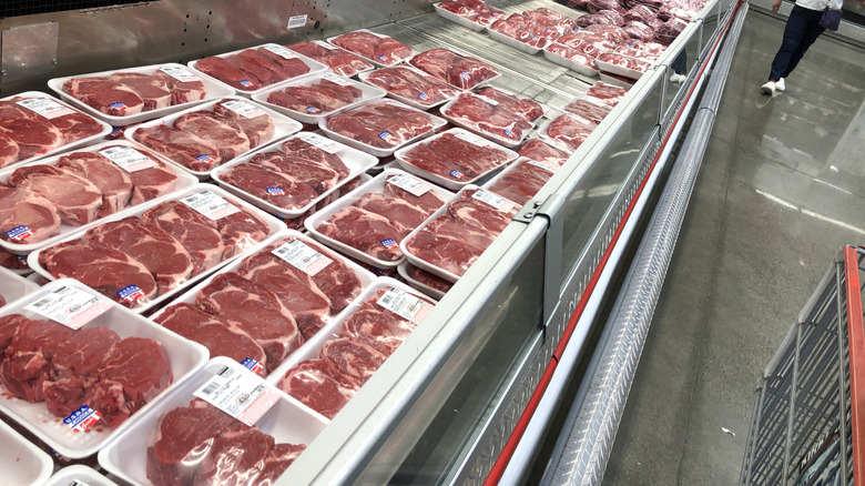 Multiple packs of raw steak products in a Costco store