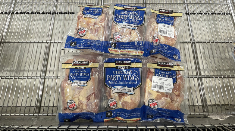 Packs of Kirkland Signature Chicken Party Wings sitting in a refrigeration unit