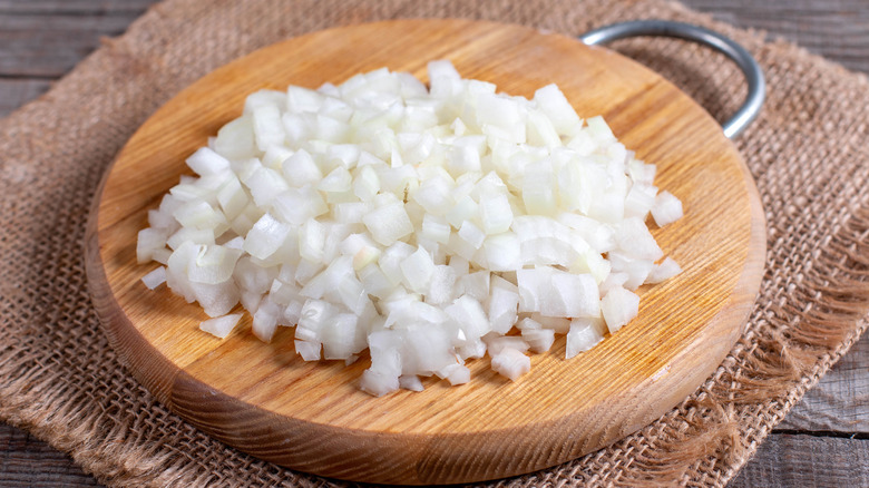 chopped onions on cutting board