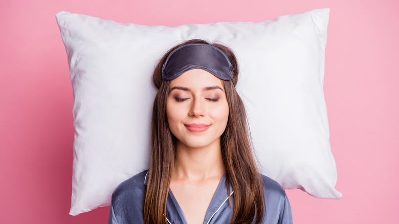 sleeping woman on pink background