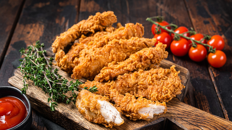 Breaded chicken on a board