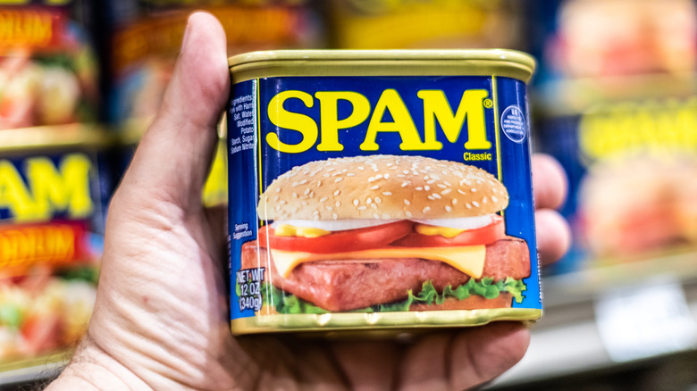 hand holding can of SPAM