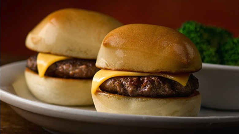 Two cheeseburger sliders on plate