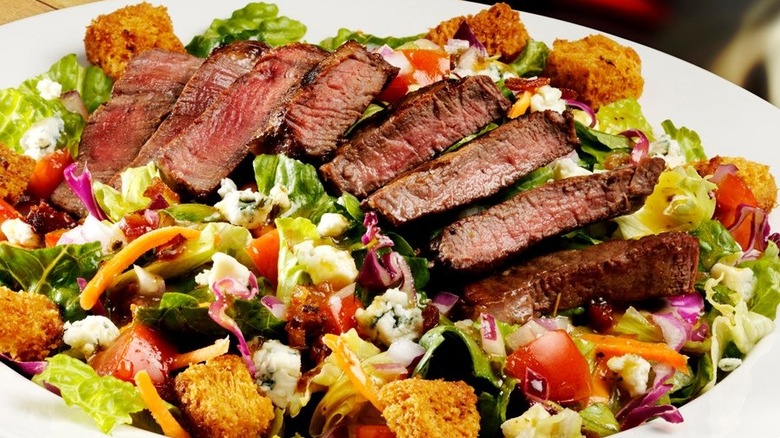 Steak salad on white plate