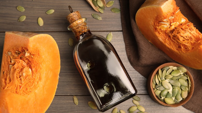 cut pumpkin and pumpkin oil