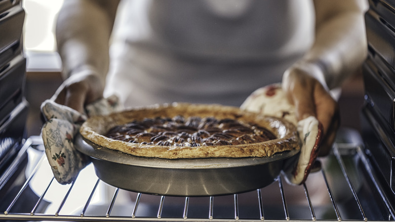 Pecan pie being placed in an oven