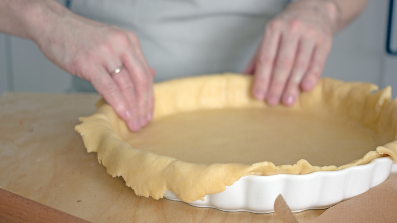 Placing dough in a pastry dish