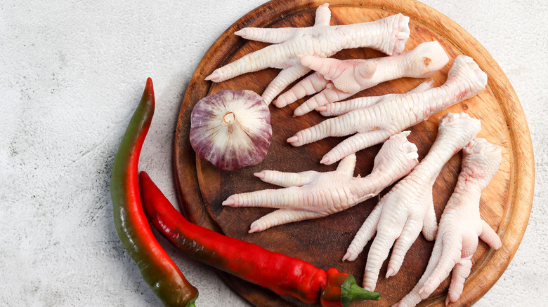 chicken feet on wooden board