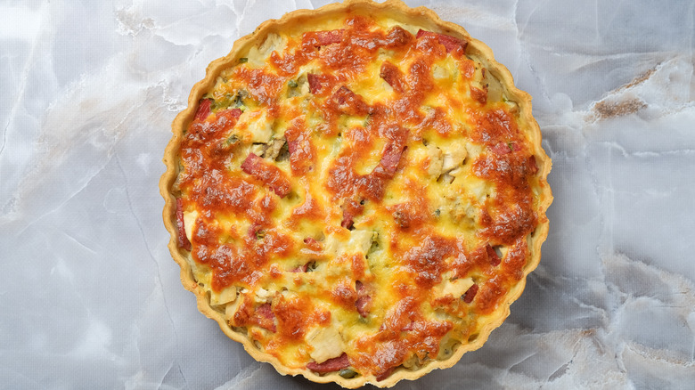 whole quiche on marble table