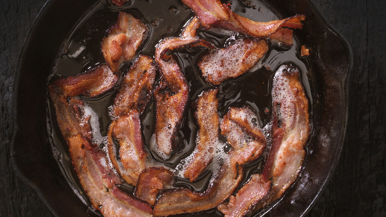 Bacon frying in cast-iron skillet