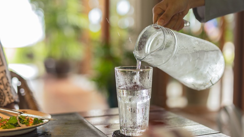 pouring ice water in glass