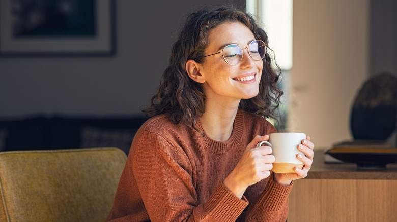 person smiling drinking tea