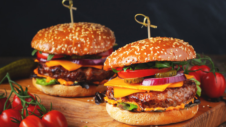 Two hamburgers on a board