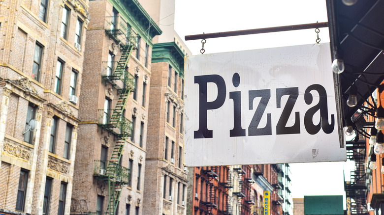 Pizza sign hanging outside of a restaurant in New York City