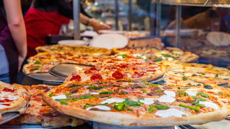 Various pizzas in pizzeria window