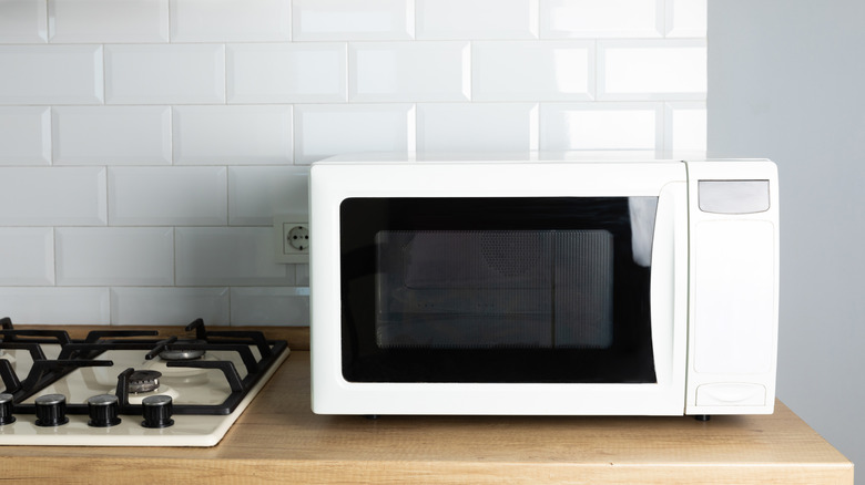 white microwave sitting on a kitchen countertop