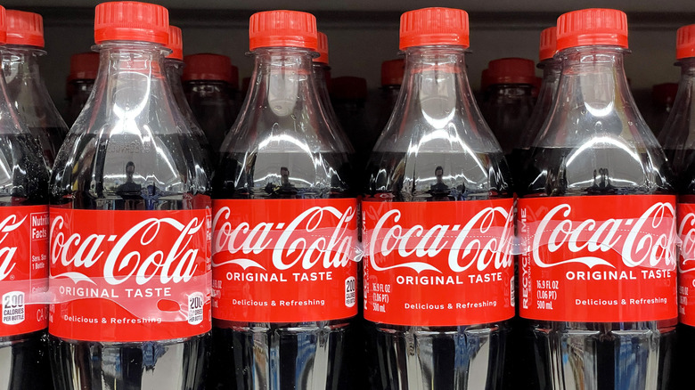 Plastic bottles of Coca-Cola displayed in supermarket