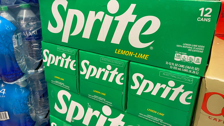 12-packs of Sprite cans stacked up in supermarket