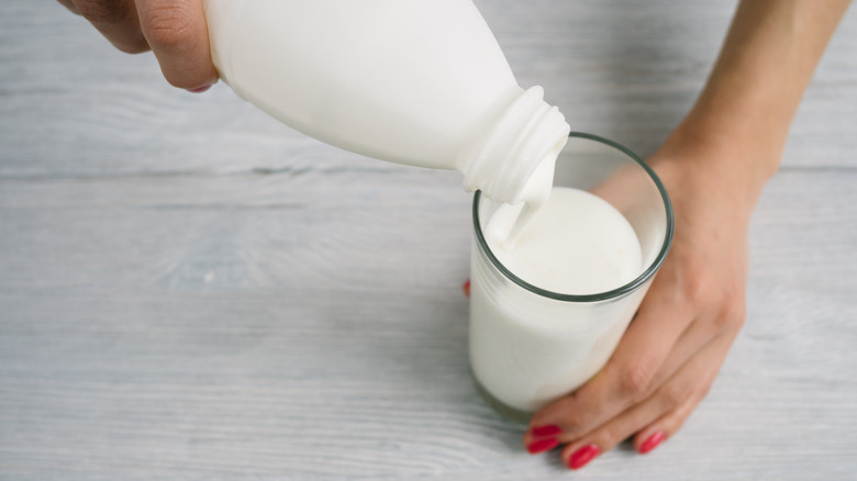 kefir being poured out of bottle