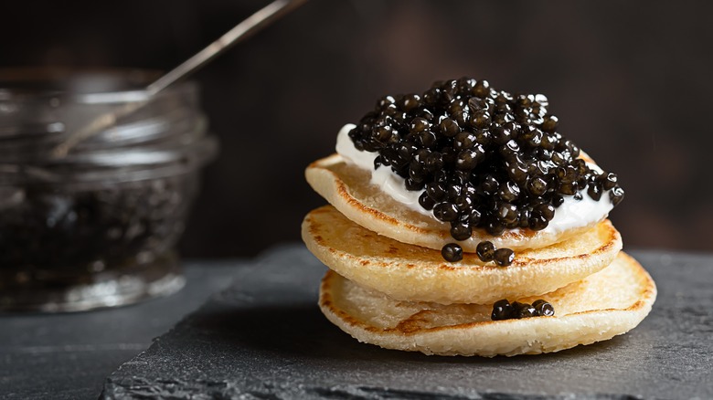 black caviar-topped blini