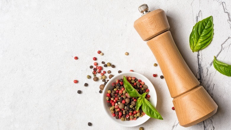 Peppercorns and pepper mill