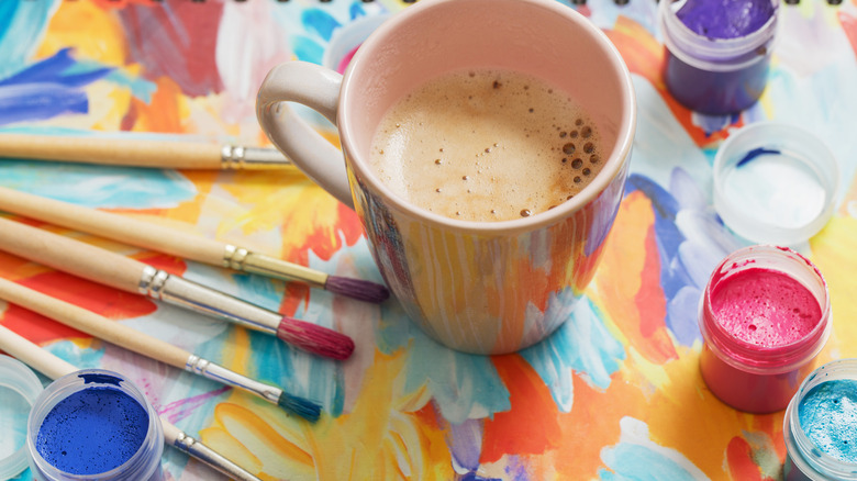 coffee cup on colorful painting