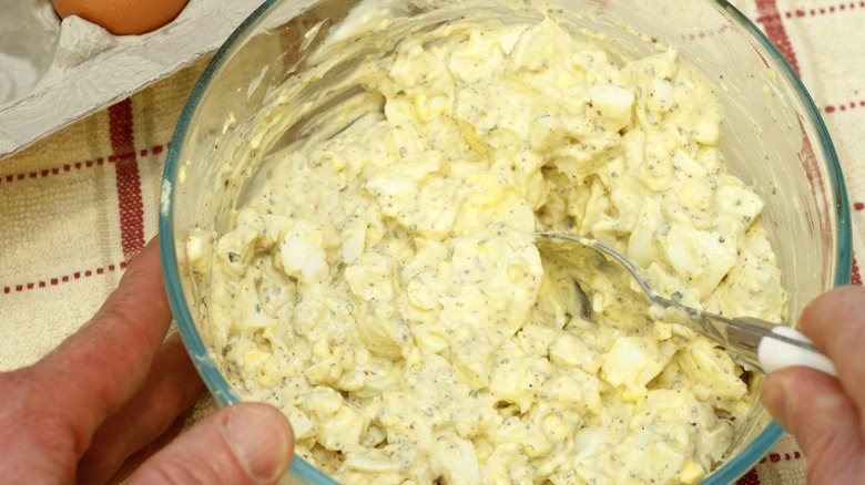 mixing egg salad