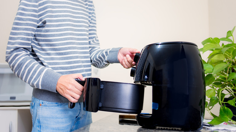 Person using air fryer