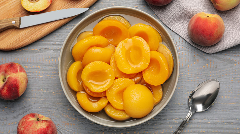 canned peach halves in bowl