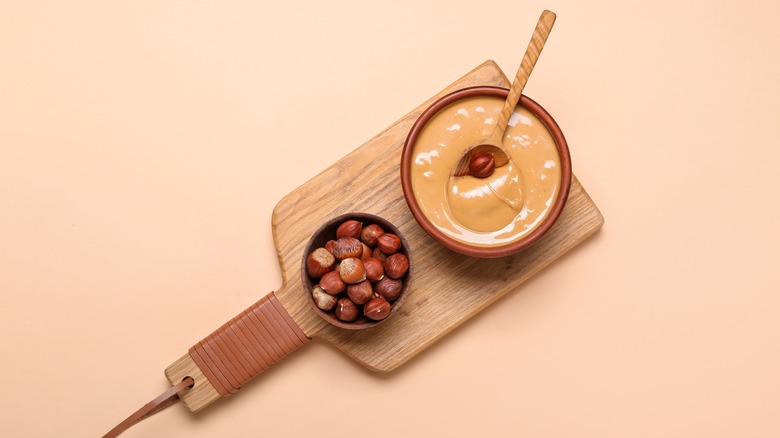 reddish-beige hazelnut butter on wooden board