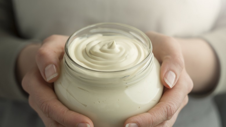 Woman holding jar of mayonnaise