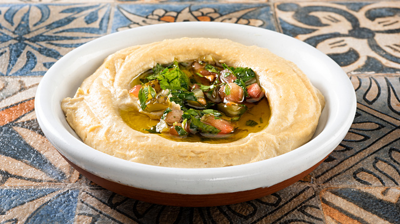 Bowl of hummus with herbs