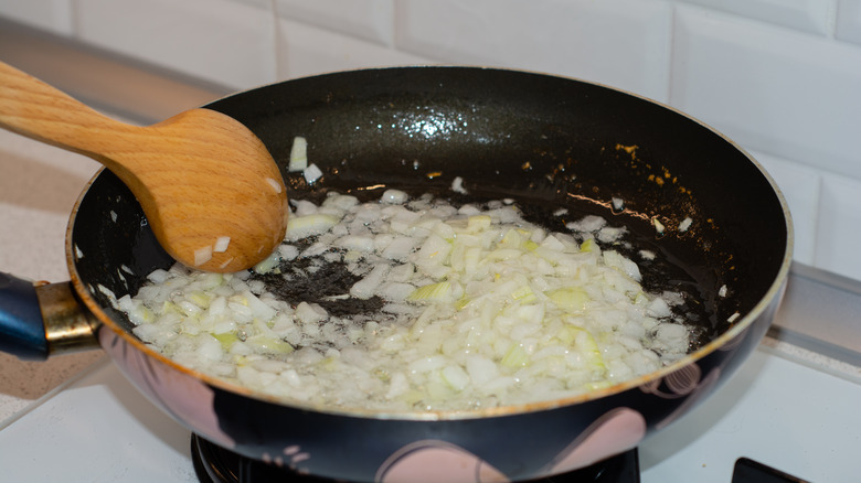 Onions sautéing in a pan