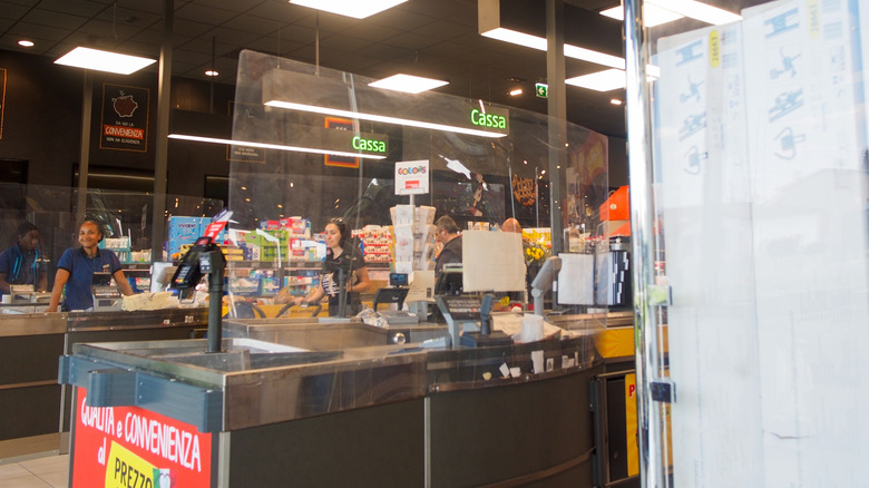 Aldi checkout at a store in Italy, with staff in the background