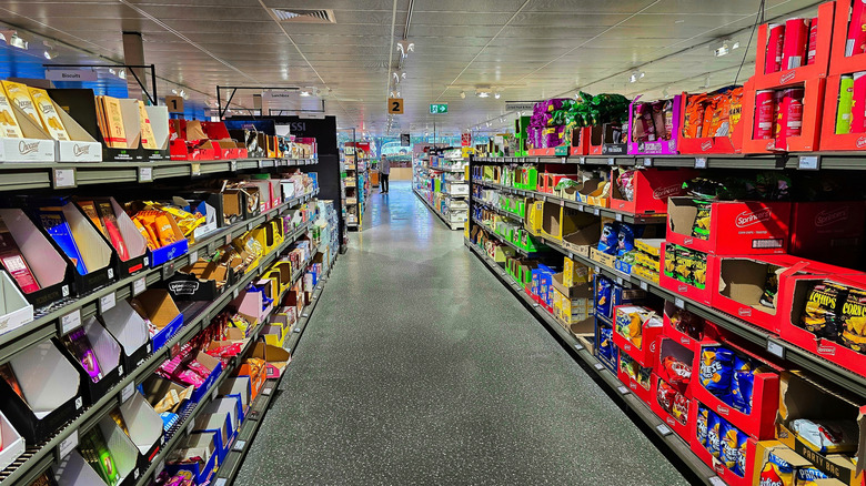 Interior of Aldi store, showing a wide aisle with products on either side