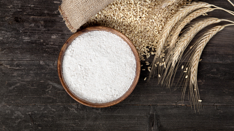 bowl of flour next to wheat