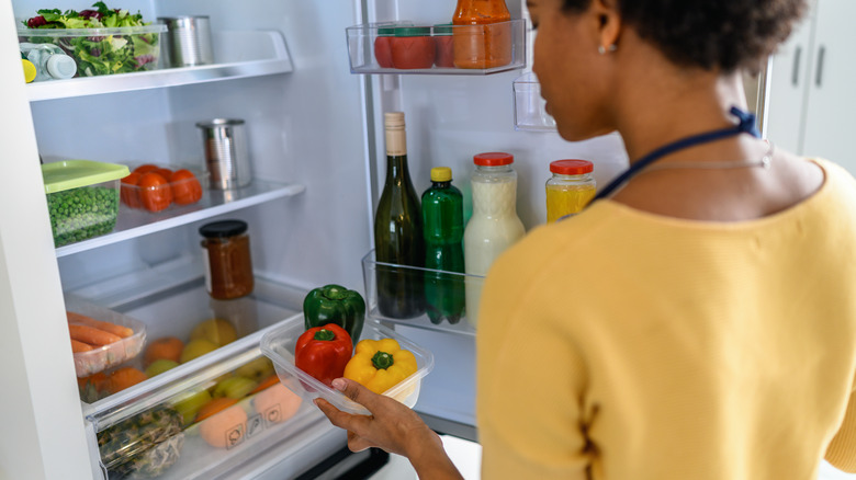 person looking into fridge