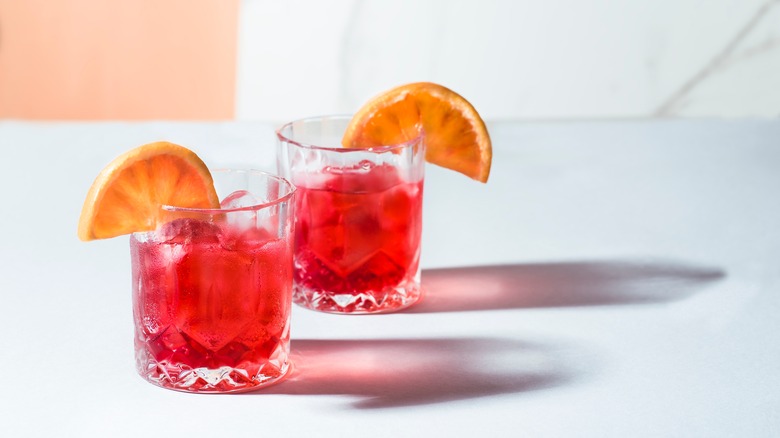 two cocktails with oranges