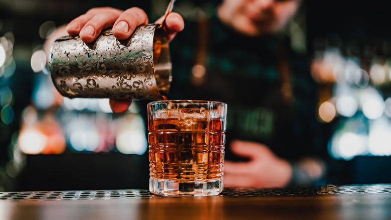 bartender pouring cocktail