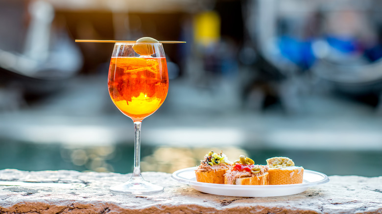 spritz cocktail and plate of food