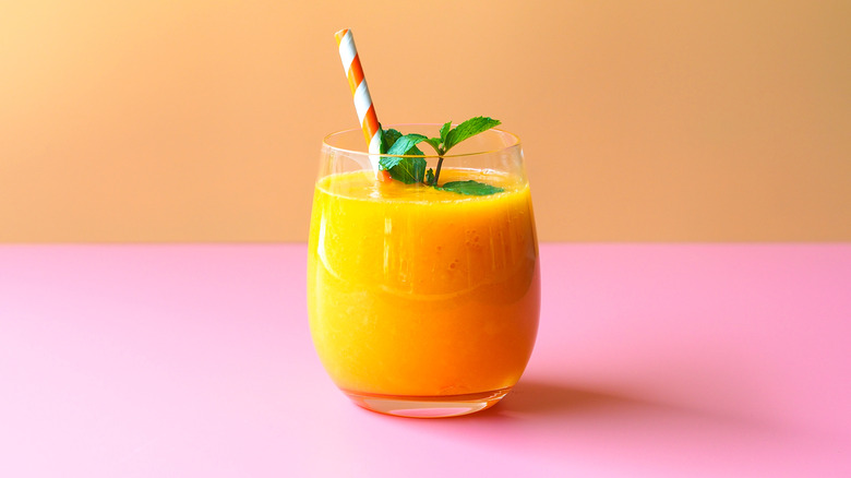 Mango smoothie with straw