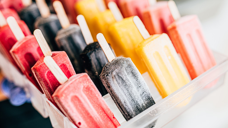 tray of colorful fruit popsicles