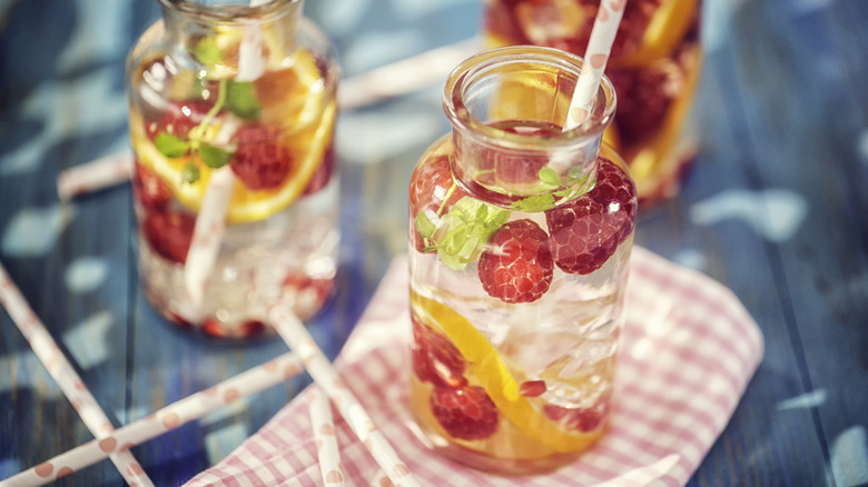 water with berries and oranges