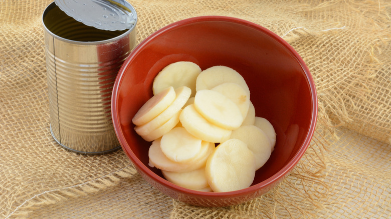 canned sliced potatoes in red bowl