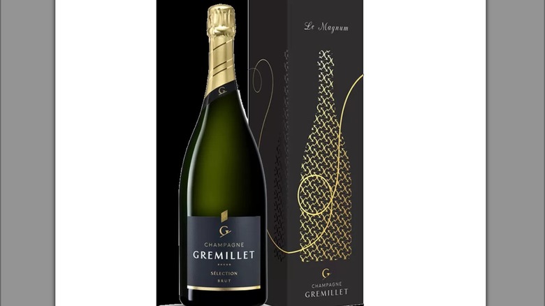 bottle of Gremillet Champagne and box on a white background