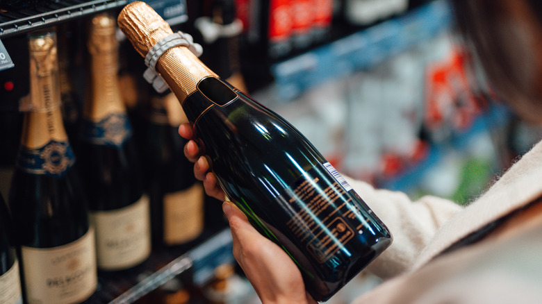 shopper holding bottle of Champagne