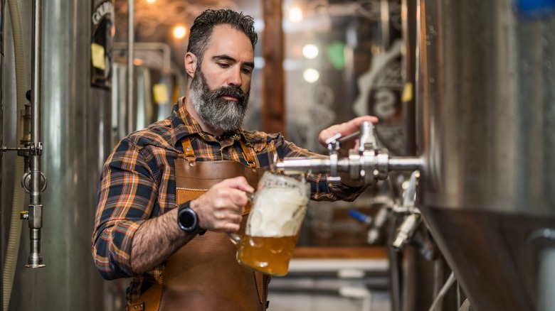 Man pulling beer at a brewery