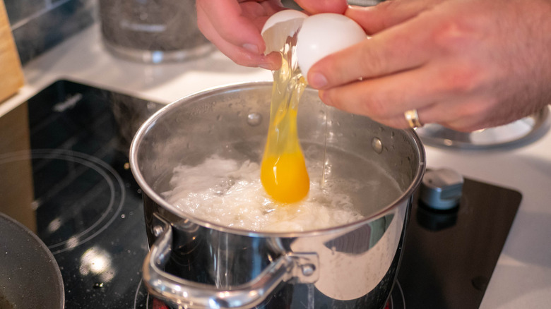 Cracking egg into pot